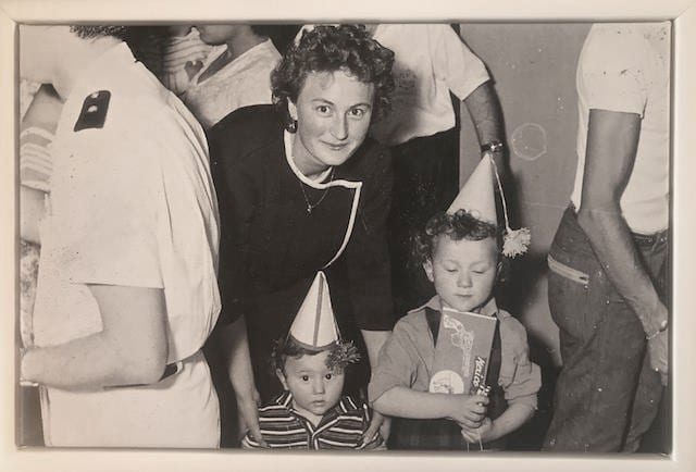 Black & white picture of a mother with her kids, celebrating their birthday