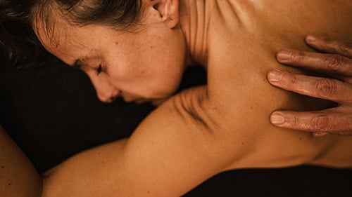 Female bartender pouring drink and feeling anxious about being pressured not to claim workers' compensation by her boss